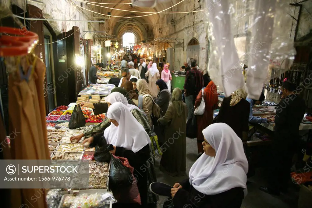 Women buy sweets at a market in the old city section of Jerusalem
