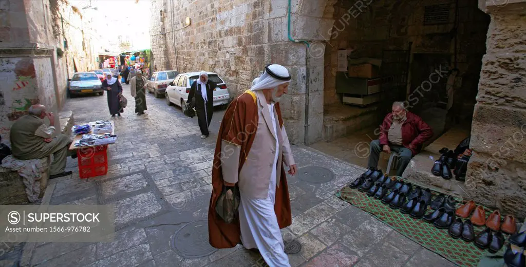 A Muslim man examines shoes at a market in the old city section of Jerusalem