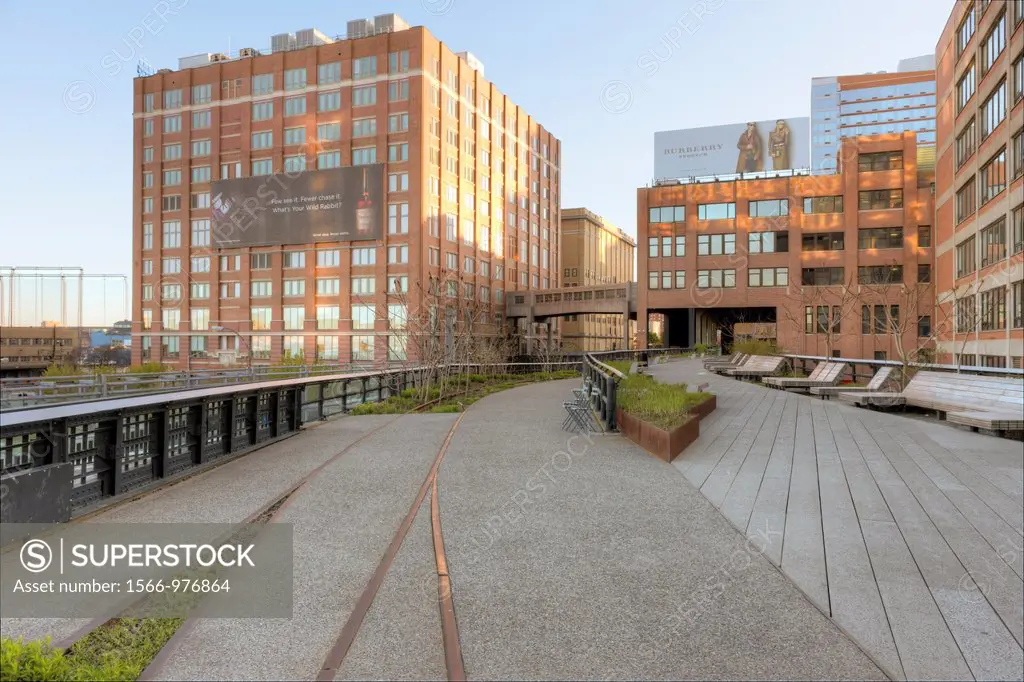 A view of High Line Park, including old railroad tracks left in place, and the surrounding area. The High Line is an urban aerial greenway reclaimed f...