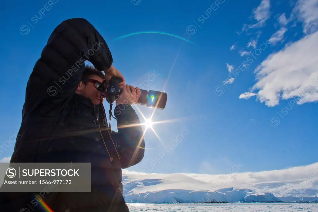 Staff from the Lindblad Expedition ship National Geographic Explorer shown here is Photo Instructor Eric Guth working in Antarctica