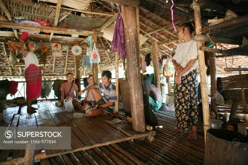 Burmese gathered in a hut in the displaced persons camp near Thailand In Myanmar Burma, thousands of people have settled near the border as a result o...
