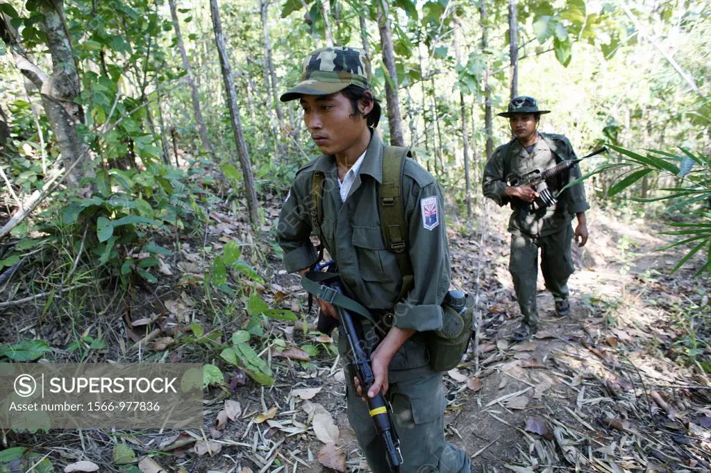 KNLA soldiers walking through the jungle near Thailand In Myanmar Burma, thousands of people have settled near the border as a result of oppression in...