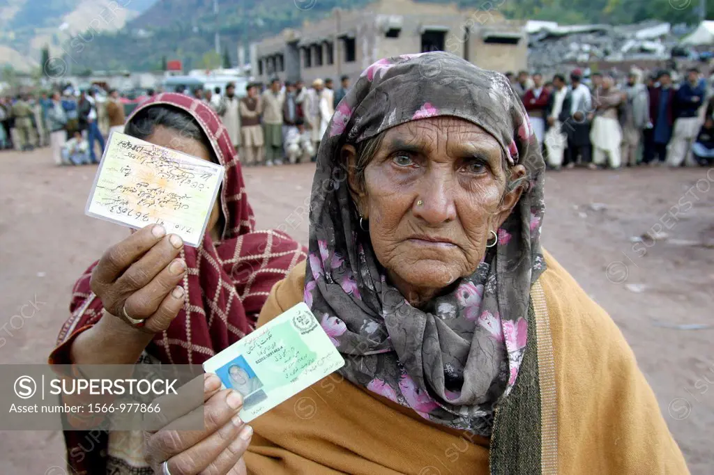 Women showing their ID cards, hoping to get also food during a distribution in Hatian, Kashmir, Pakistan On 8 october 2005, a severe earthquake hit No...