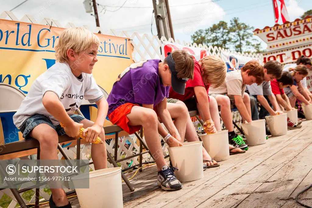 Young competitors race to husk the most corn at the World Grits Festival April 14, 2012 in St  George, SC  The festival celebrates the southern love f...