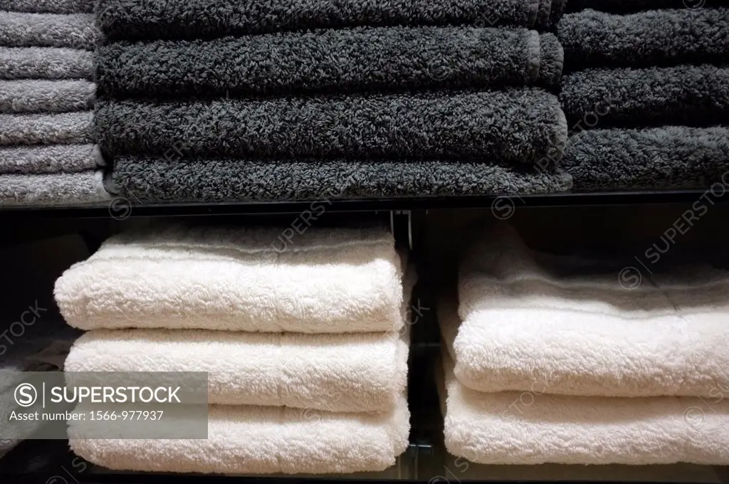 Gray and White Towels Stacked on Shelves in a Retail Store Display