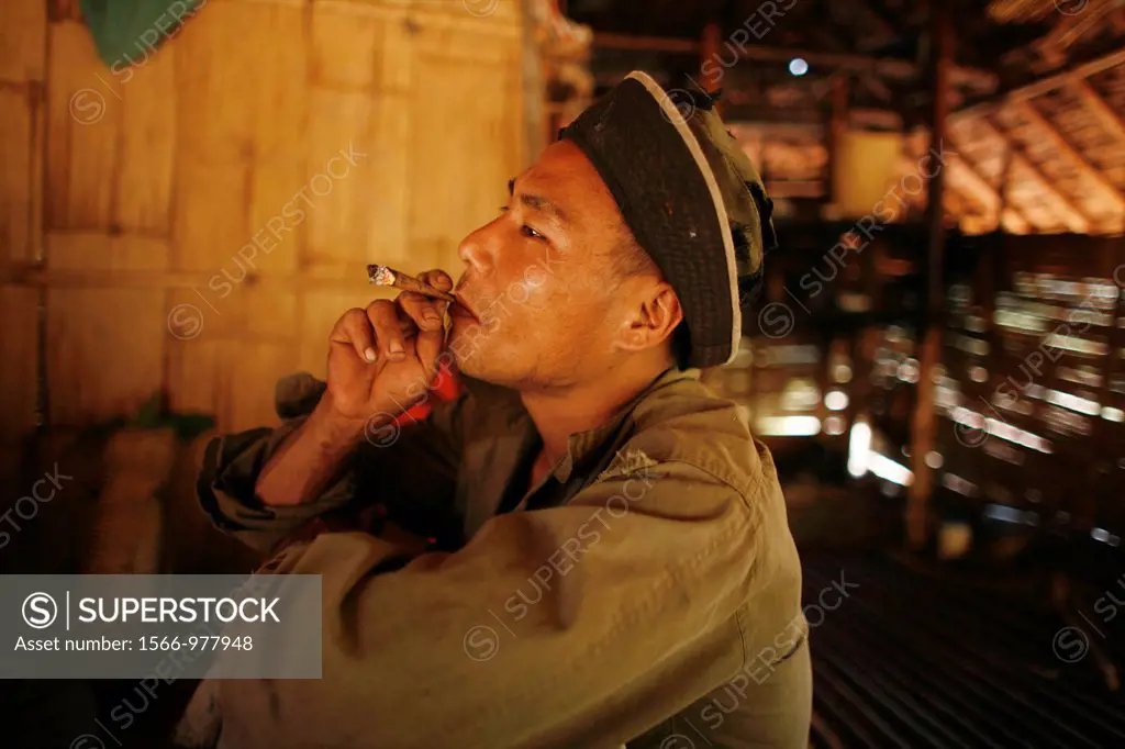 A KNLA soldier smokes a cigarette In Myanmar Burma, thousands of people have settled near the border as a result of oppression in their homeland Aroun...