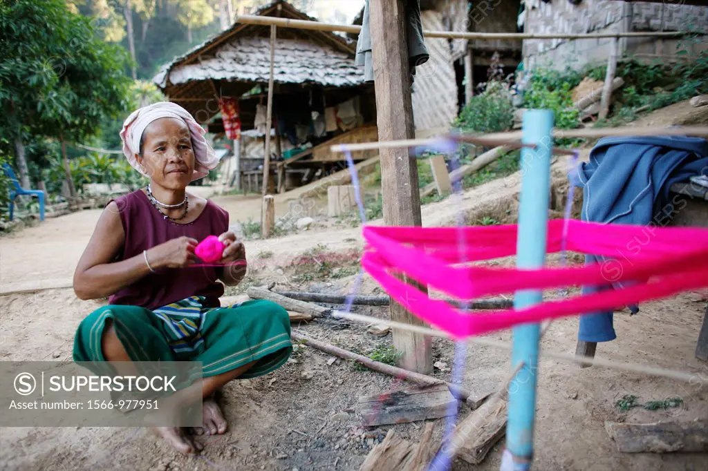 A village man wraps yarn for weaving Approximately 300 Burmese refugees in Thailand are members of the indigenous group known as the Longnecks The lar...