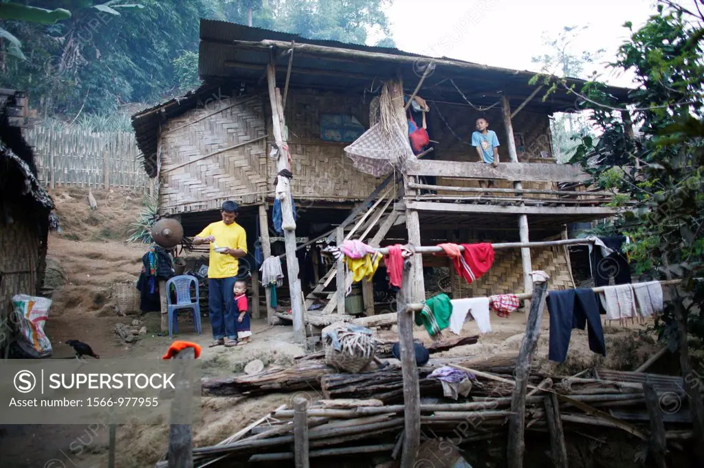 View of a home and members of a family in the Longneck refugee camp village Approximately 300 Burmese refugees in Thailand are members of the indigeno...