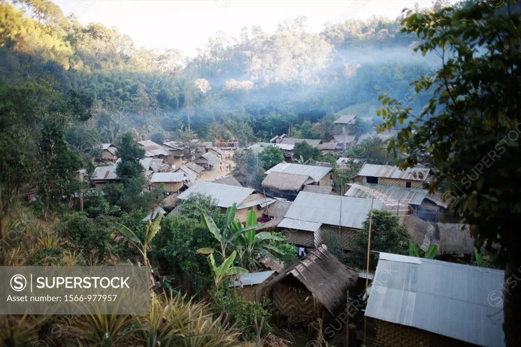 Mist hangs over the houses in the Longneck village camp Approximately 300 Burmese refugees in Thailand are members of the indigenous group known as th...