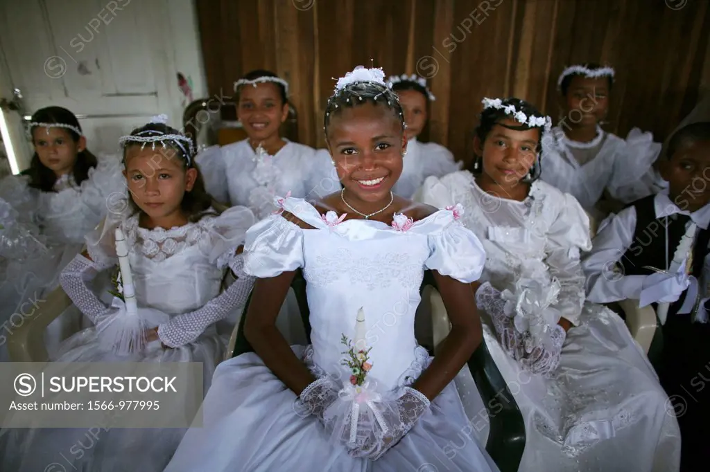 Children celebrate their first commune in the local slum church