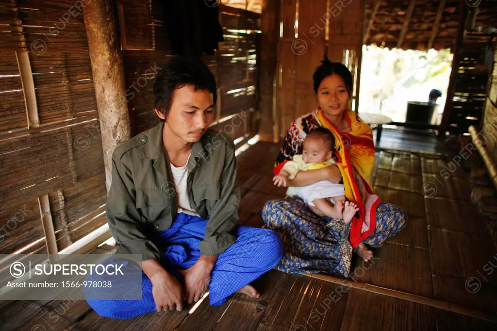 A Burmese family in their hut in La Per Her In Myanmar Burma, thousands of people have settled near the border as a result of oppression in their home...