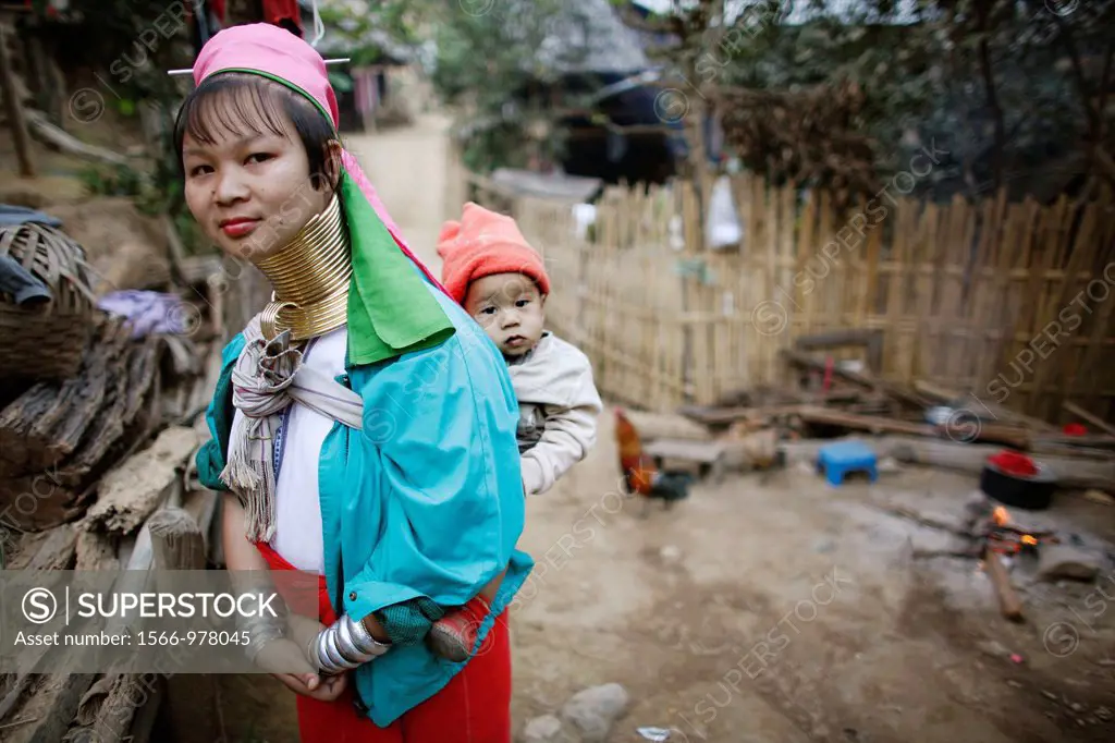 A Longneck mother carries her baby in the refugee camp village Approximately 300 Burmese refugees in Thailand are members of the indigenous group know...