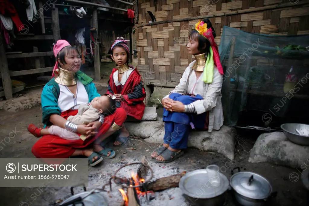Longneck women gathered around a cooking fire in the village Approximately 300 Burmese refugees in Thailand are members of the indigenous group known ...