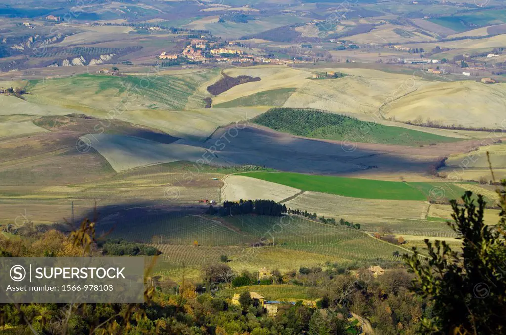 Panorama view over the field with shadows from the clouds in tuscany italy