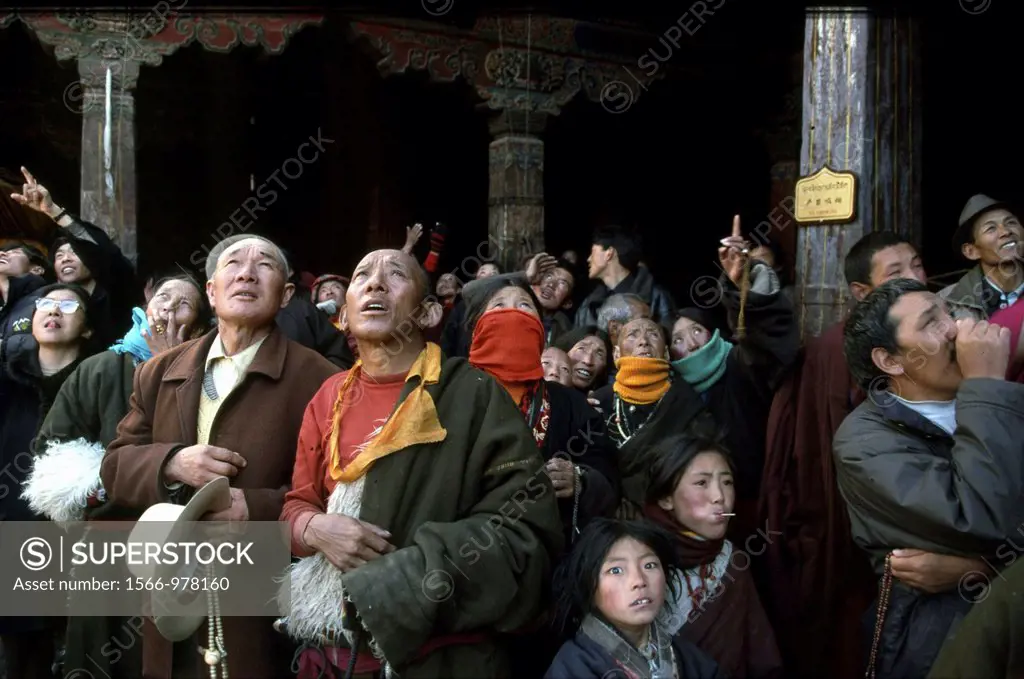 People in a monastry seeing a god in the sky and start praying It was an important religious event and people were really impressed, Lhasa in Tibet