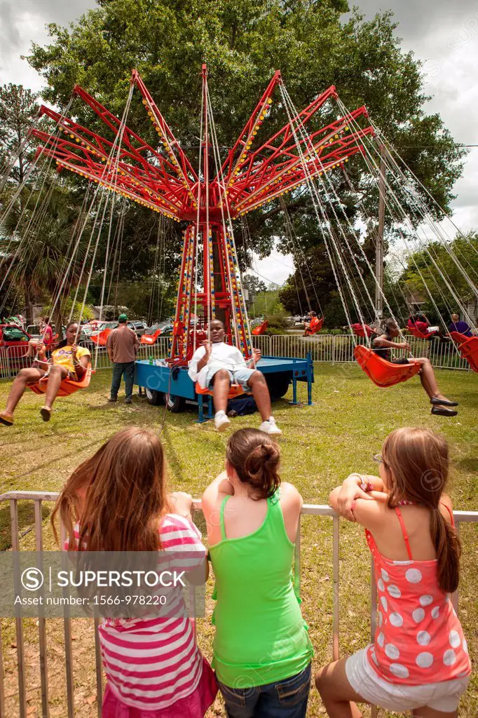 Children wait to ride an old fashion carnival swing ride at the World Grits Festival April 14, 2012 in St  George, SC  The festival celebrates the sou...