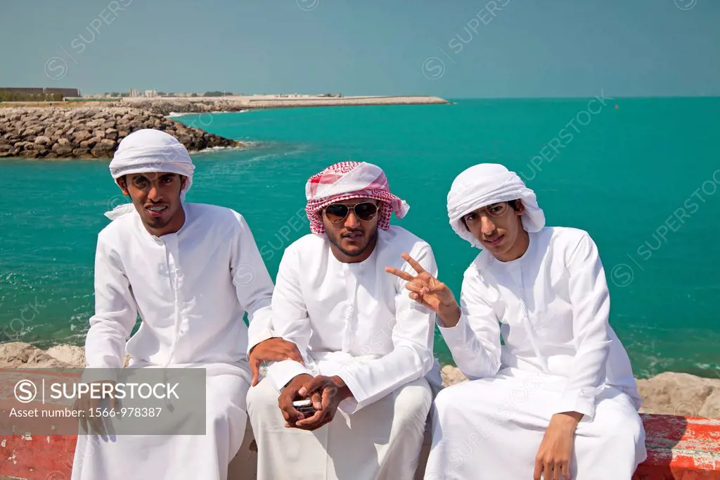 young male locals with their typical traditional arabic dress Kandora or Dishdasha, Abu Dhabi, capital city of the United Arab Emirates UAE, Asia