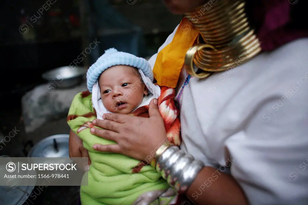 Closeup of a Longneck baby being held by its mother Approximately 300 Burmese refugees in Thailand are members of the indigenous group known as the Lo...