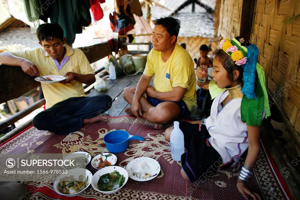 A Longneck family eats a meal together on their porch Approximately 300 Burmese refugees in Thailand are members of the indigenous group known as the ...