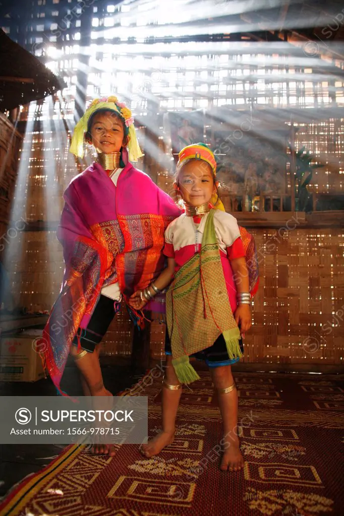 Two young Longneck girls wearing traditional dress indoors Approximately 300 Burmese refugees in Thailand are members of the indigenous group known as...