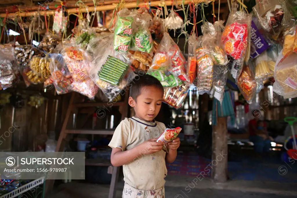 A child outside a shop in the displaced persons camp near the border with Thailand In Myanmar Burma, thousands of people have settled near the border ...