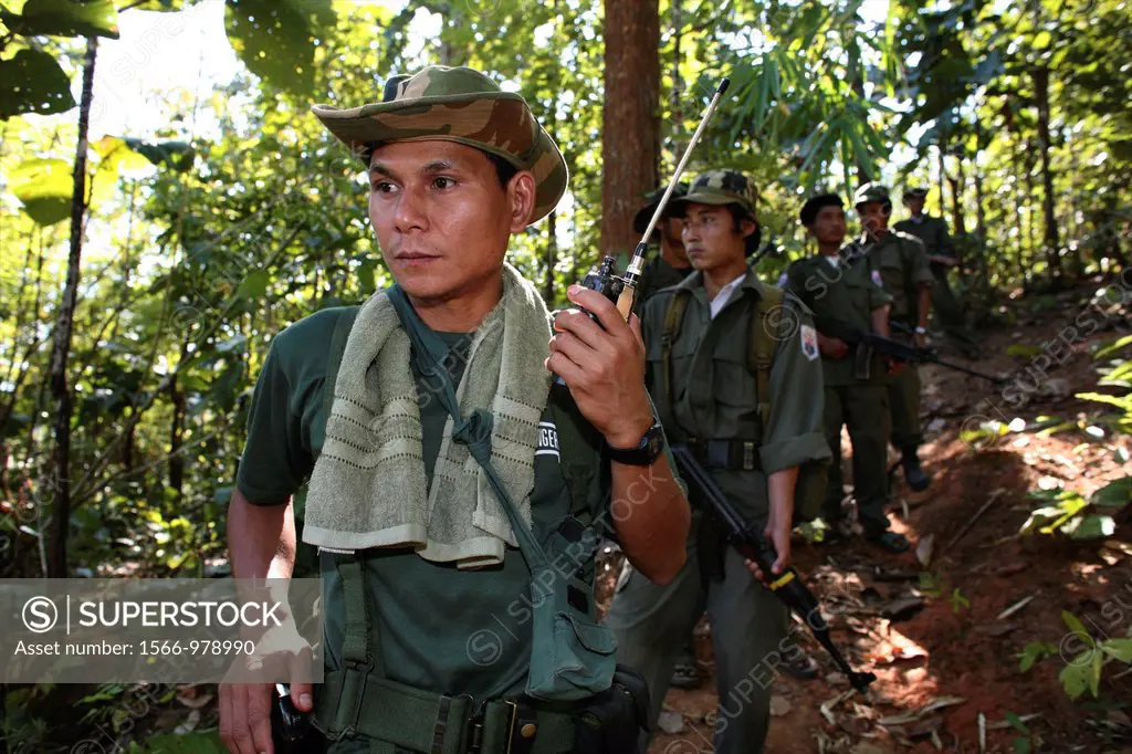 A KNLA soldier listening to a radio device near the border with Thailand In Myanmar Burma, thousands of people have settled near the border as a resul...
