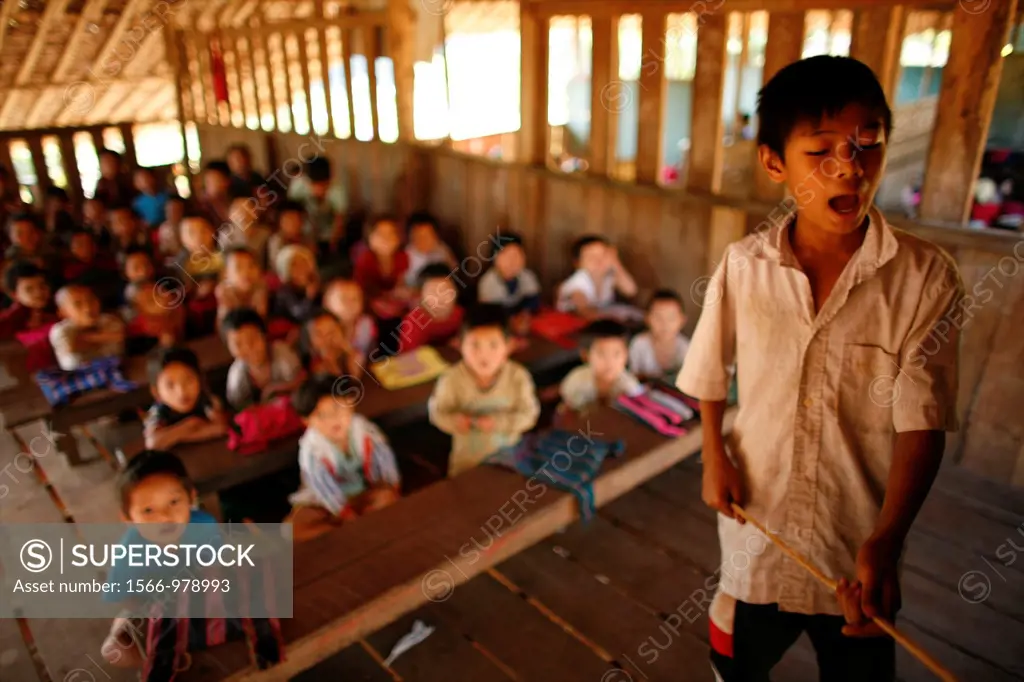 A young teacher in front of the class in the village school in La Per Her In Myanmar Burma, thousands of people have settled near the border as a resu...