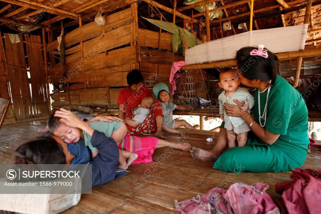 An extended Burmese family in their home near the border with Thailand In Myanmar Burma, thousands of people have settled near the border as a result ...