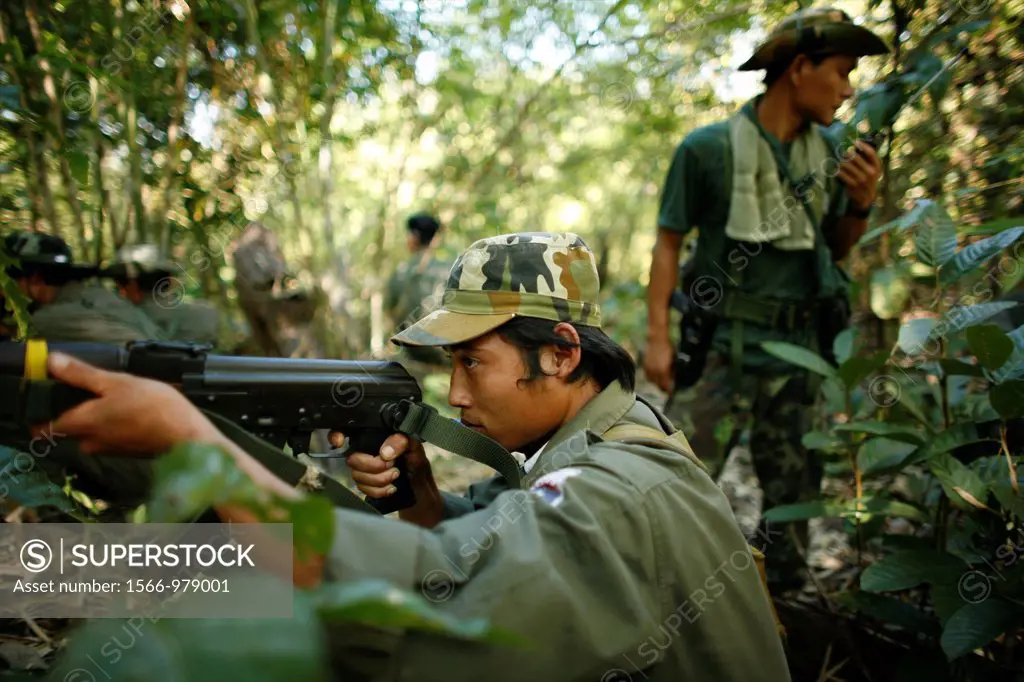 A KNLA soldier takes aim in the jungle around La Per Her In Myanmar Burma, thousands of people have settled near the border as a result of oppression ...