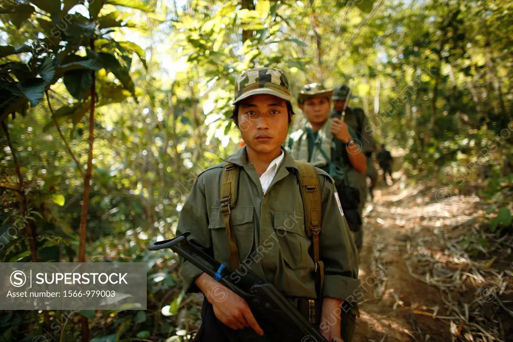 KNLA soldiers walk through the jungle In Myanmar Burma, thousands of people have settled near the border as a result of oppression in their homeland A...