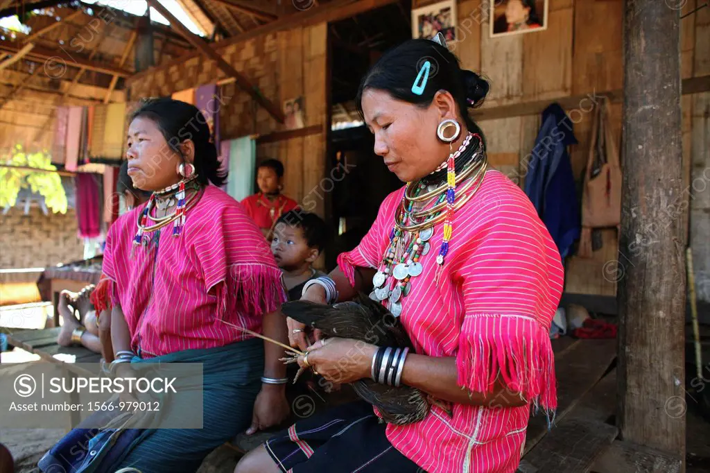 Burmese women gathered outside a house in the camp Approximately 300 Burmese refugees in Thailand are members of the indigenous group known as the Lon...