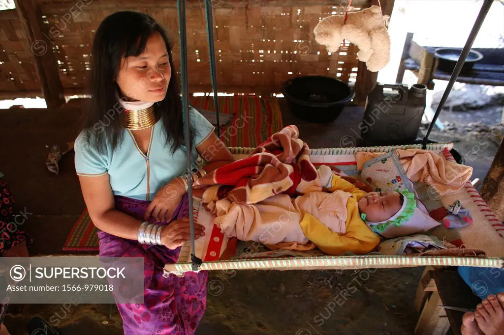 A Longneck woman with her sleeping child in a suspended crib Approximately 300 Burmese refugees in Thailand are members of the indigenous group known ...