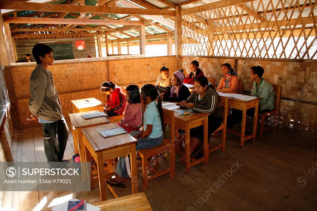 Refugee children at their desks in school Approximately 300 Burmese refugees in Thailand are members of the indigenous group known as the Longnecks Th...