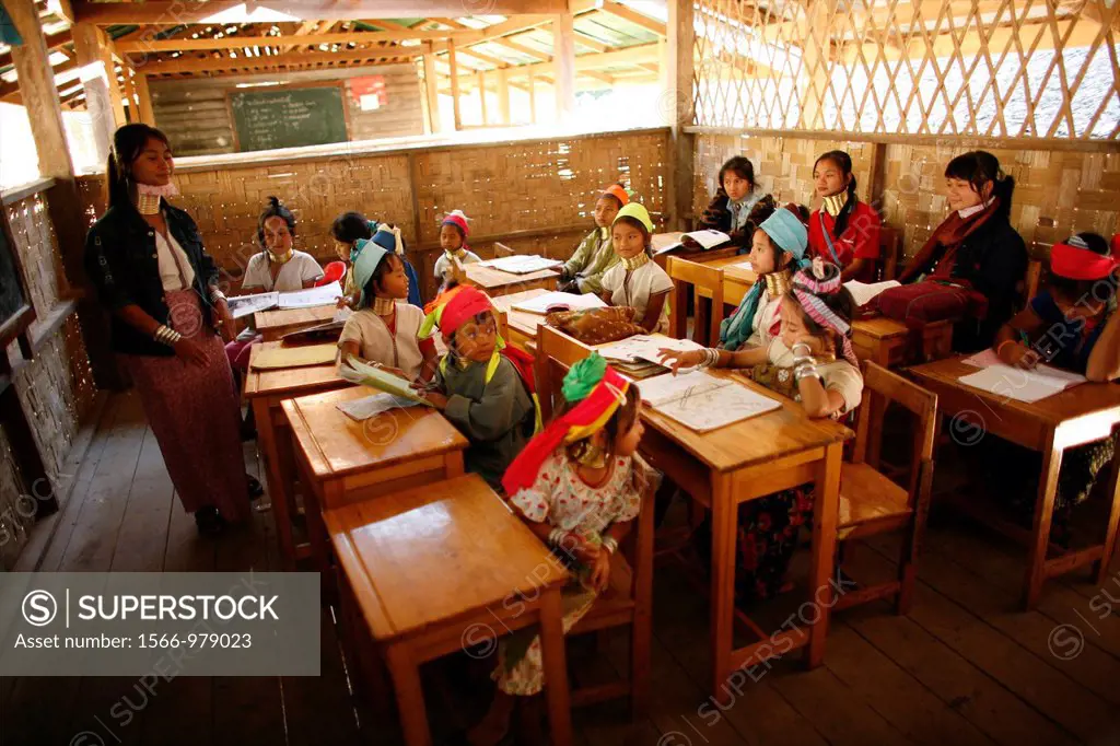 A Longneck teacher and her students in the classroom Approximately 300 Burmese refugees in Thailand are members of the indigenous group known as the L...