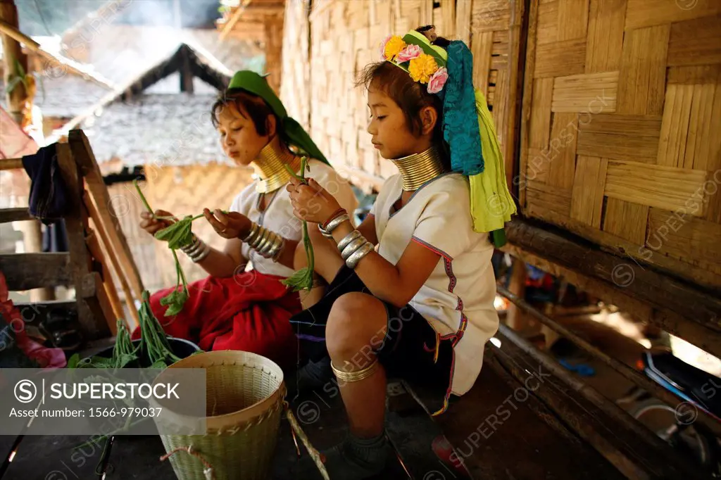 Longneck girls prepare food for a meal Approximately 300 Burmese refugees in Thailand are members of the indigenous group known as the Longnecks The l...