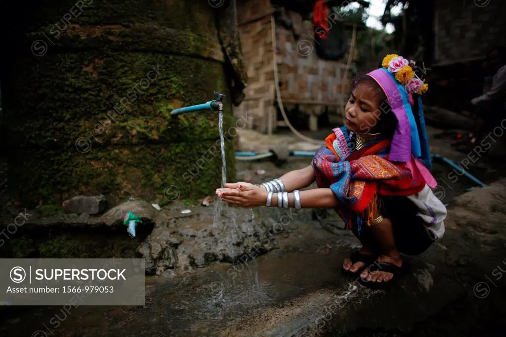 A Longneck girl washes her hands at a public tap Approximately 300 Burmese refugees in Thailand are members of the indigenous group known as the Longn...
