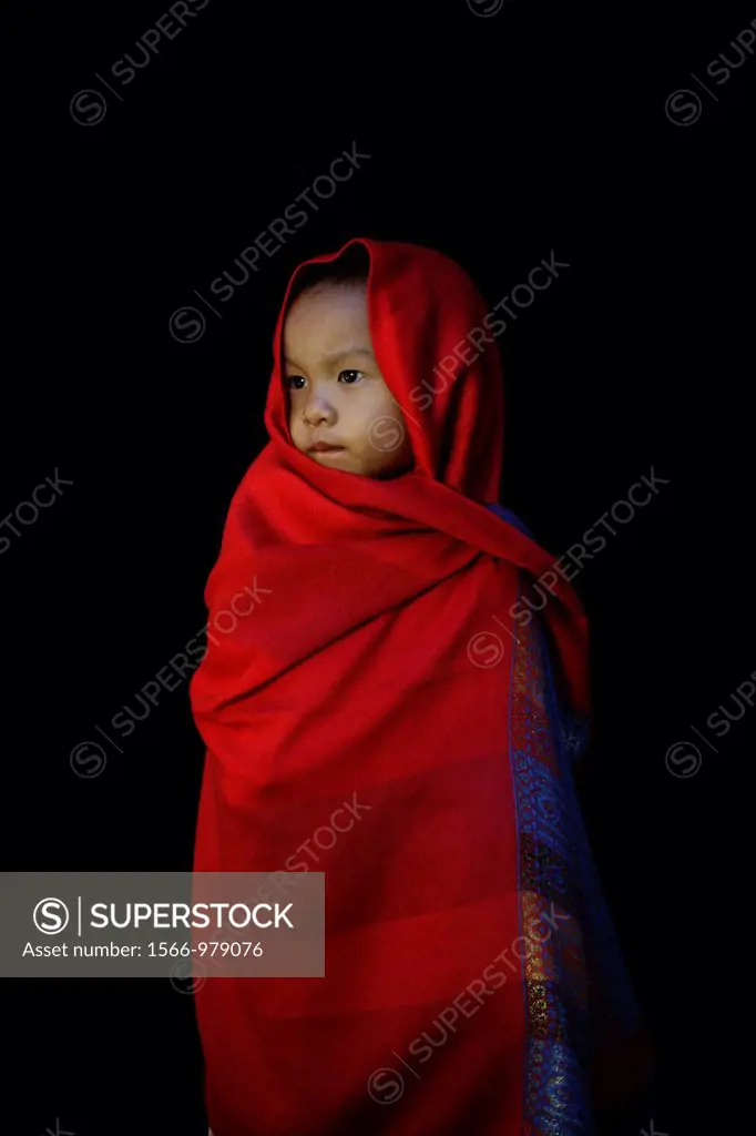 Portrait of a Longneck child wrapped in a shawl Approximately 300 Burmese refugees in Thailand are members of the indigenous group known as the Longne...