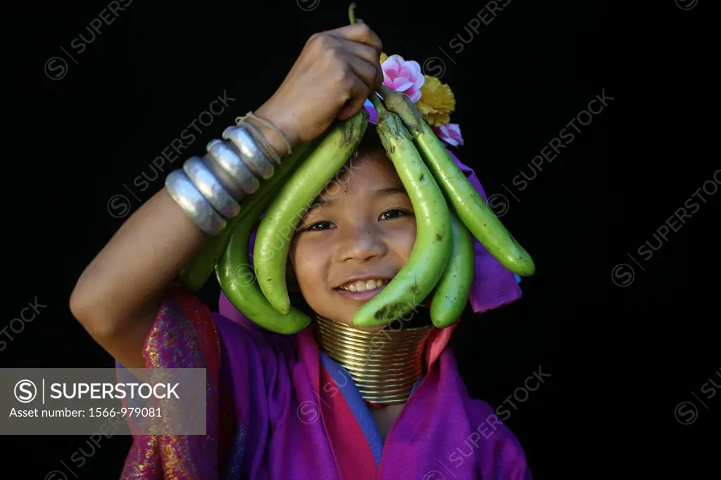 A young Longneck girl holds ripe fruit Approximately 300 Burmese refugees in Thailand are members of the indigenous group known as the Longnecks The l...