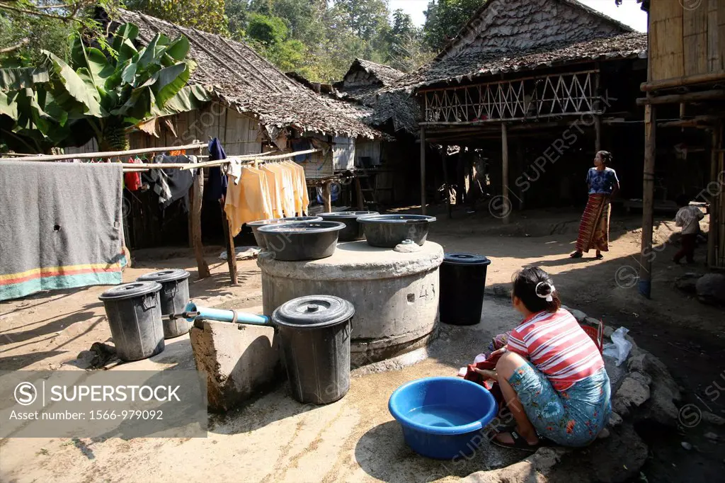 A refugee woman washes clothes in the camp Around 130,000 Burmese refugees have settled in Thailand due to opression in their homeland of Myanmar Burm...