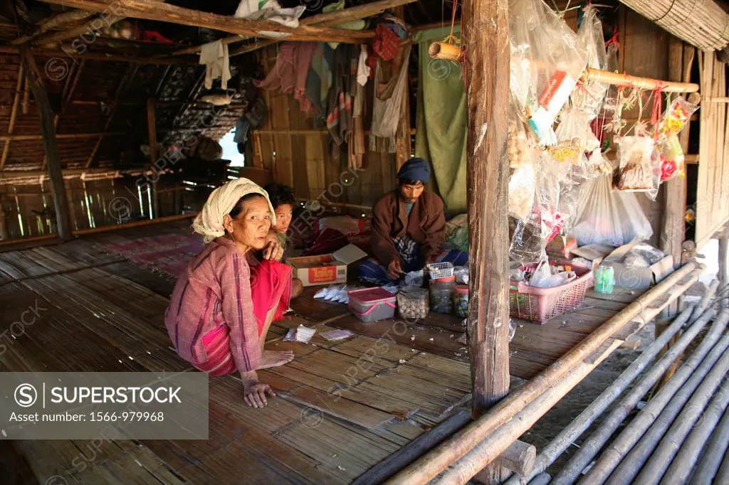 Burmese family in a hut in the displaced village near the Thai border In Myanmar Burma, thousands of people have settled near the border as a result o...
