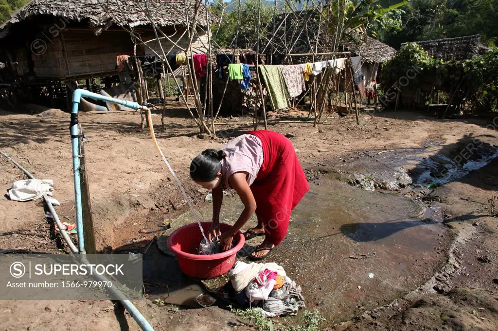 A Burmese woman washes clothes in the displaced person camp near the border with Thailand In Myanmar Burma, thousands of people have settled near the ...