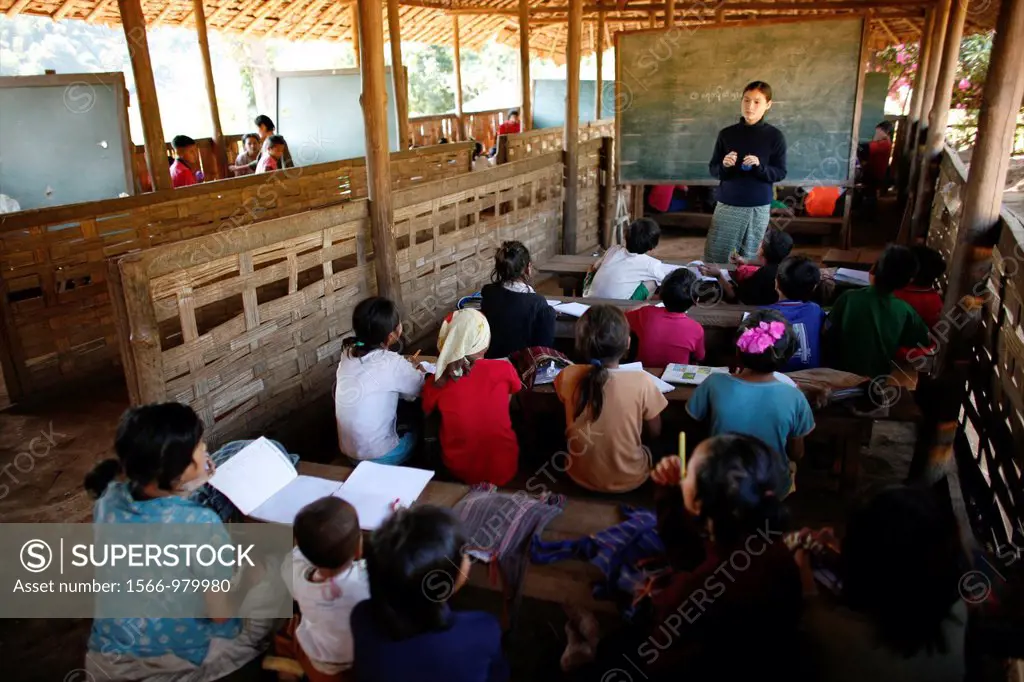 A teacher addresses her class in the village school in La Per Her In Myanmar Burma, thousands of people have settled near the border as a result of op...