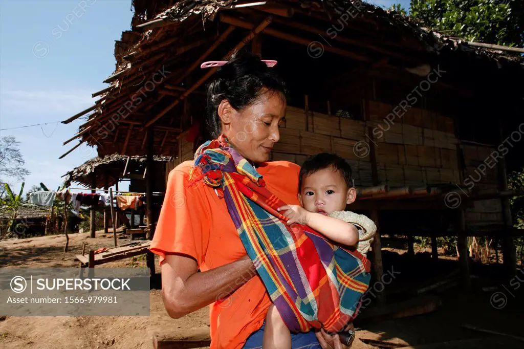 A Burmese woman carrying her baby in La Per Her In Myanmar Burma, thousands of people have settled near the border as a result of oppression in their ...