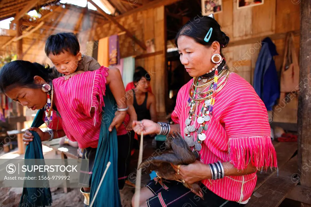 Burmese women carry out daily life activities on house porch Approximately 300 Burmese refugees in Thailand are members of the indigenous group known ...