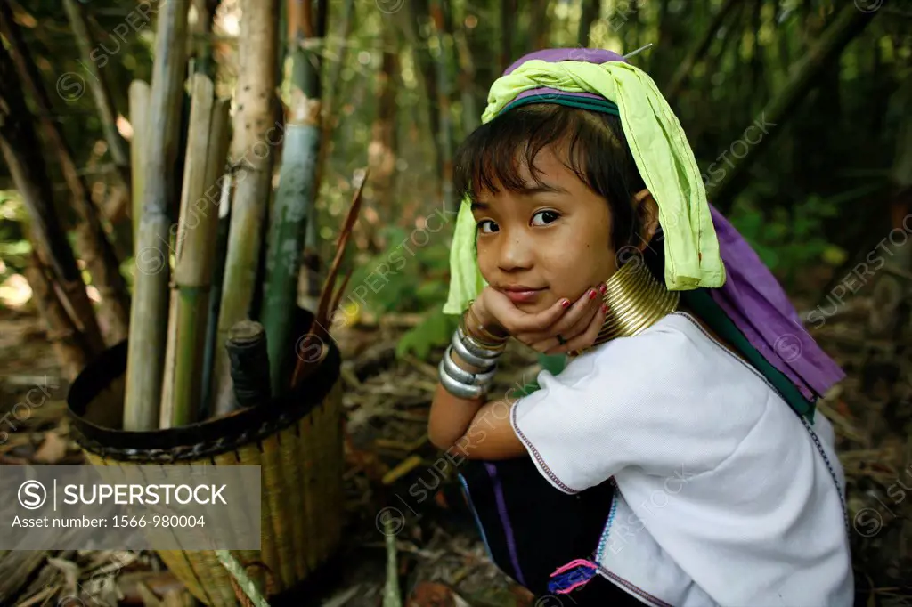 A young Longneck girl takes a break from collecting firewood outside her village Approximately 300 Burmese refugees in Thailand are members of the ind...