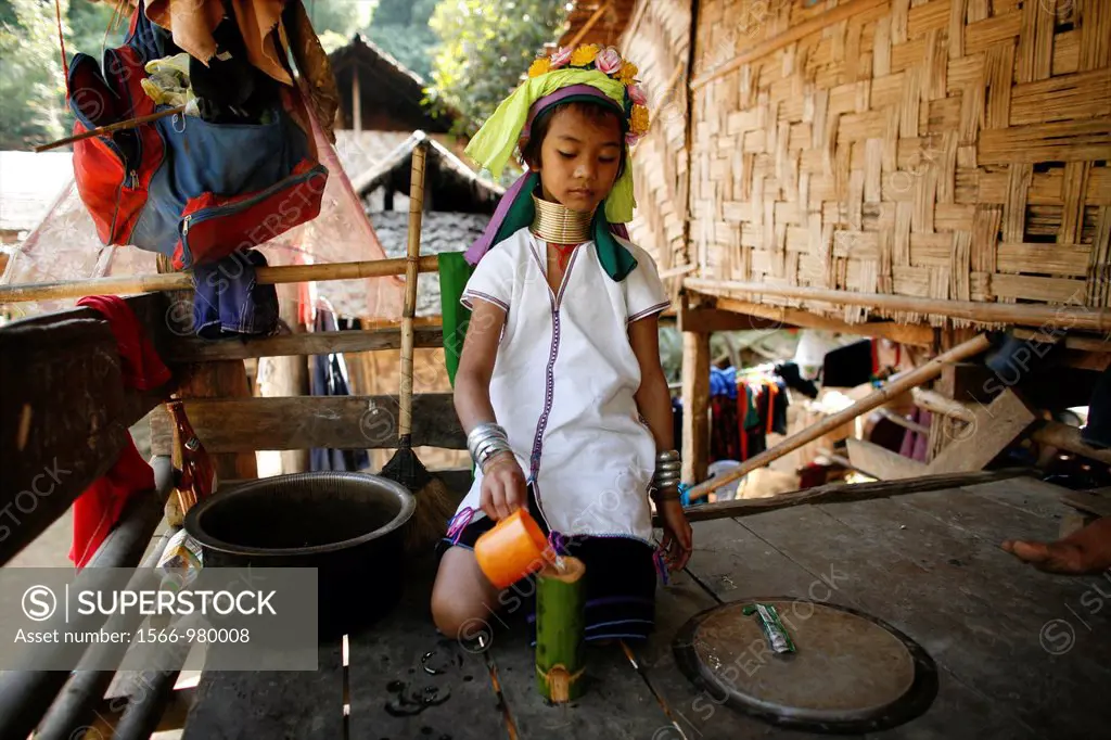 A young Longneck girl pours water into a bamboo container Approximately 300 Burmese refugees in Thailand are members of the indigenous group known as ...