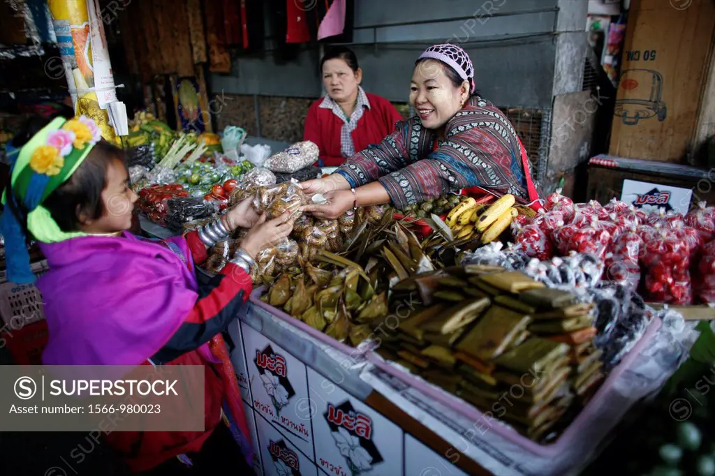 A Longneck girl buys vegetables at a market Approximately 300 Burmese refugees in Thailand are members of the indigenous group known as the Longnecks ...