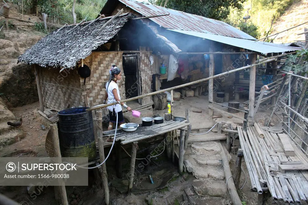 A Longneck girl cooking on her porch Approximately 300 Burmese refugees in Thailand are members of the indigenous group known as the Longnecks The lar...