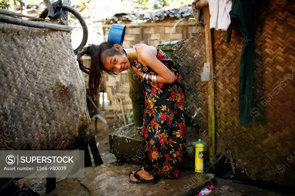 A Longneck girl showers outside her home Approximately 300 Burmese refugees in Thailand are members of the indigenous group known as the Longnecks The...