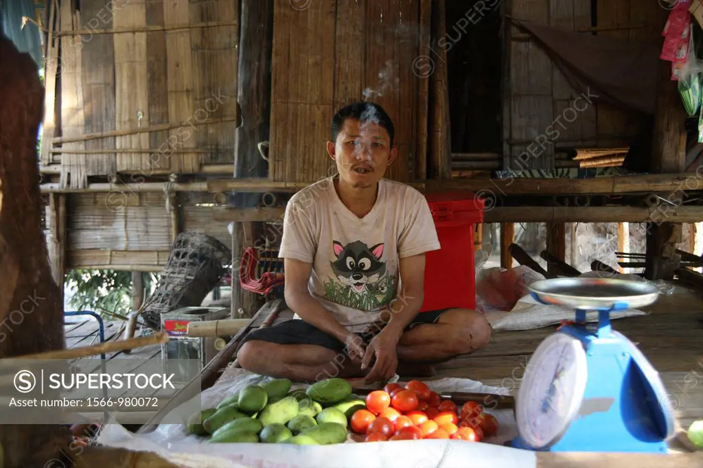 A man sells vegetables in the refugee camp in Mae Sot Around 130,000 Burmese refugees have settled in Thailand due to opression in their homeland of M...